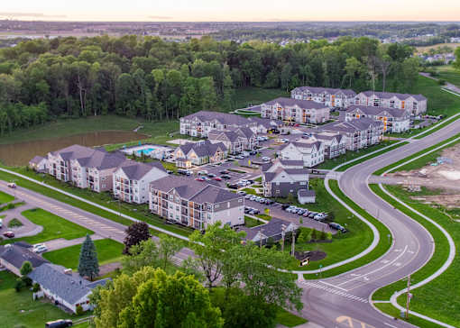 an aerial view of a housing complex with cars parked on the street and trees at The Bend, Lancaster