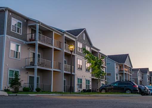 a row of apartment buildings with cars parked in front at The Bend, Lancaster, Ohio