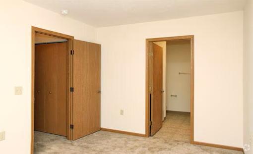 A room with a brown door and a white door.