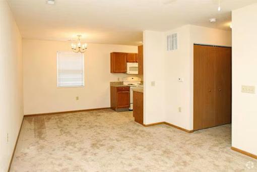 A room with a kitchenette and a window.