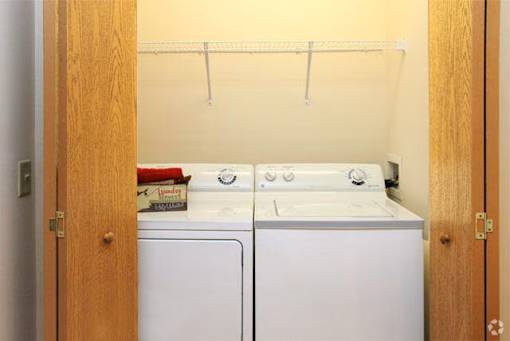 A small laundry room with a washer and dryer.