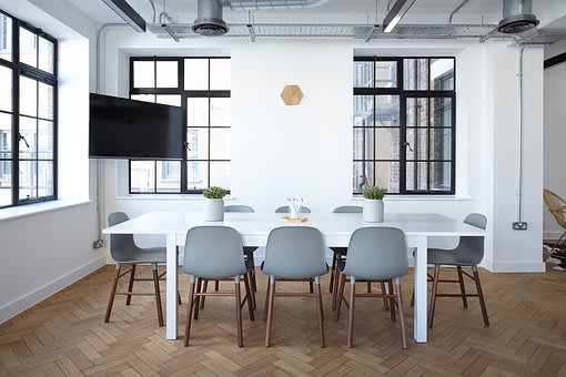 a large white table and chairs in a room