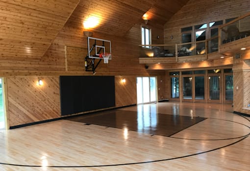 a basketball court in a wood paneled gym