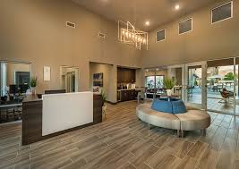 a large living room with a couch and a chandelier