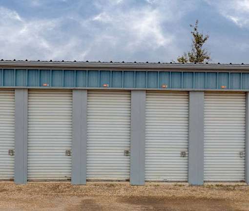 A row of grey garage doors are closed.