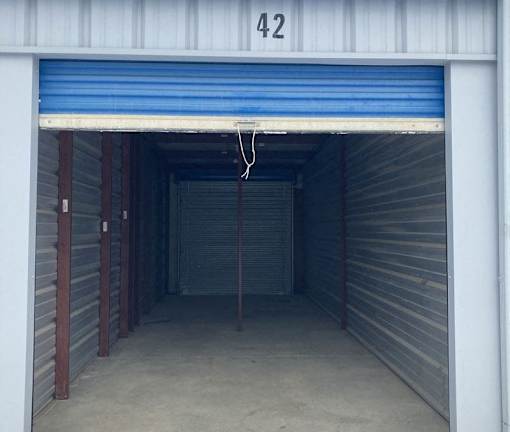 A storage unit numbered 42 with a blue roller shutter door.