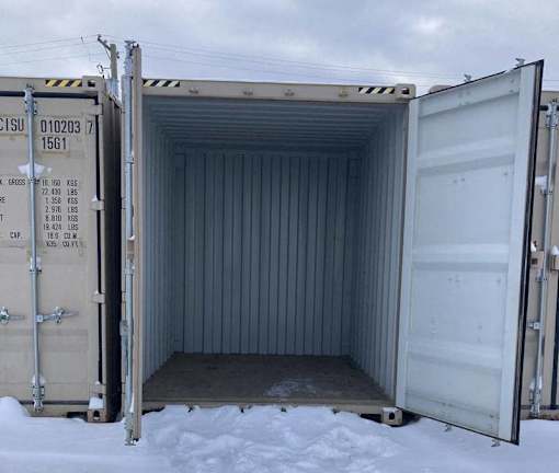 A shipping container is open and empty.