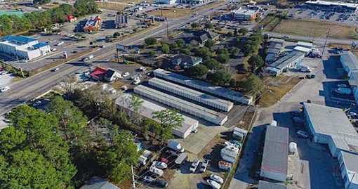 An aerial view of a busy intersection with multiple buildings and vehicles.