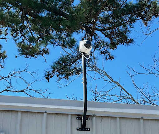 A security camera is mounted on a pole.