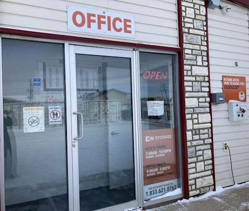 A sign on a building reads "OFFICE" in red letters.