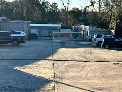 a parking lot filled with cars and a building