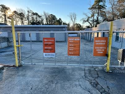 a gate with signs on it in a school yard