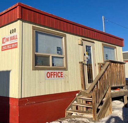 a small office building with a wooden stairs