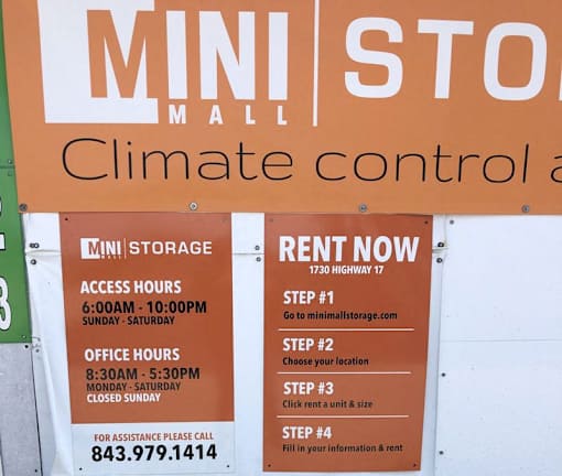 A sign for Mini Mall Climate Control advertises their services and contact information.