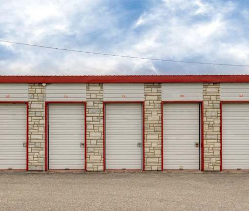 A row of garage doors with a red and white striped border.