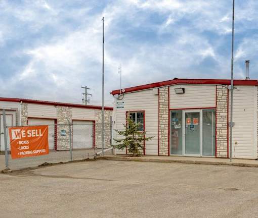 A building with a sign that says "We Sell Boxes, Locks, and Packing Supplies."