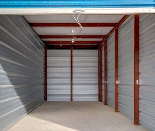 A storage unit with a blue ceiling and grey walls.