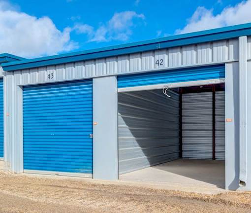 A blue and white storage facility with doors numbered 42 and 43.
