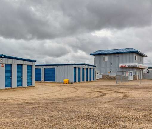 A storage facility with a sign that reads "STORAGE" and a phone number.