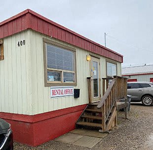 a red and white building with a porch and stairs
