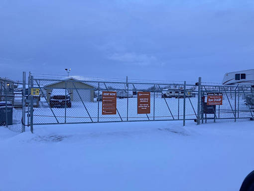 a yard with a chain link fence with signs on it