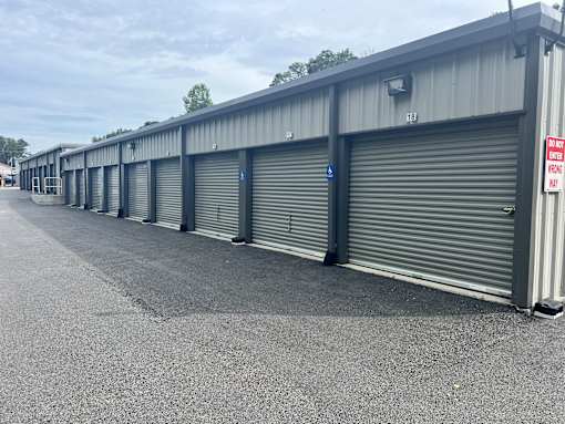 A long row of storage units with doors closed.