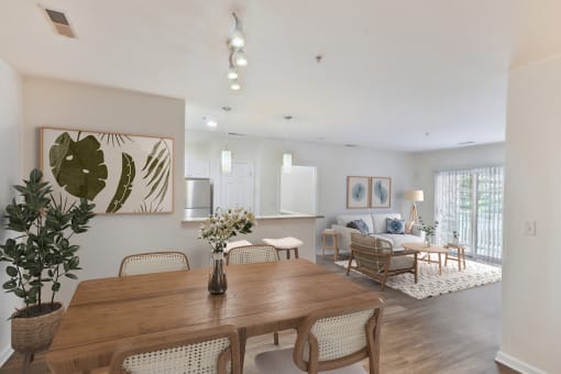 a living room and dining room with a wooden table and chairs at Highlands at Faxon Woods, Quincy, Massachusetts