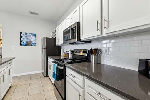 A Kitchen with Black Appliances at Flats on Chapel Apartments, Waco, 76712