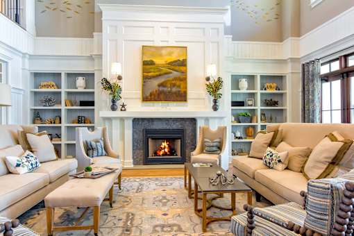 A living room with a fireplace and a painting above it.