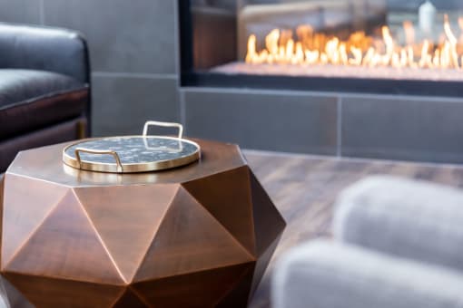 a coffee table in front of a fireplace in a living room