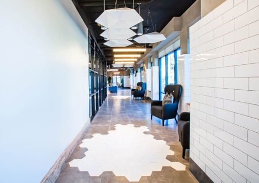 a long corridor with blue chairs and white tile on the floor at 511 Meeting, Charleston, South Carolina