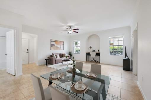A dining room with a glass table and chairs.