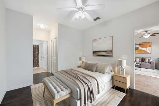 A bedroom with a large bed and a ceiling fan.