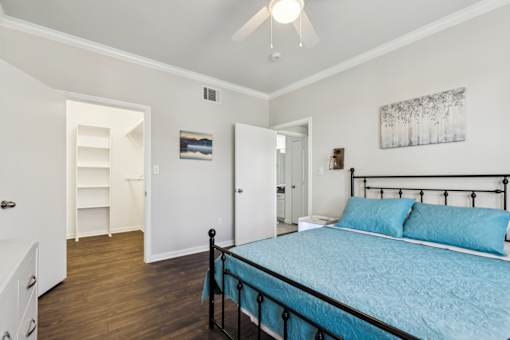 A Bedroom with a Dresser at Flats on Chapel Apartments, Waco, TX