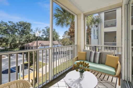 a patio with a couch and a table on a balcony at Grandeville on Saxon, Orange City