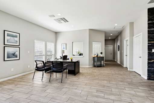 A Spacious Room with a Desk and Chairs at Flats on Chapel Apartments, Waco, Texas