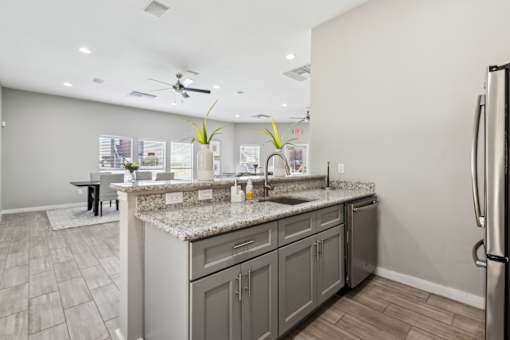 A Kitchen with a Marble Countertop at Flats on Chapel Apartments, Waco, Texas