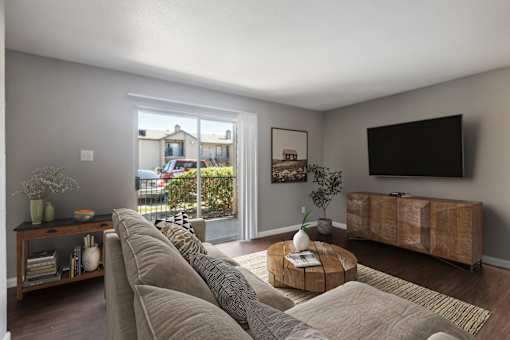 A living room with a large couch and a flat screen TV.