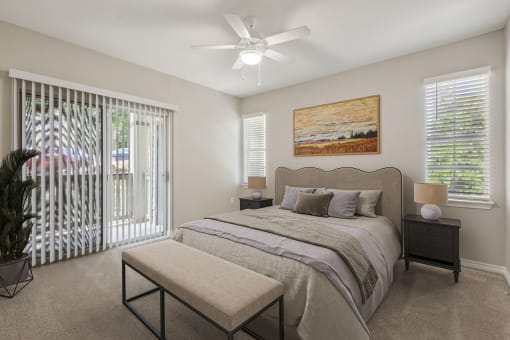 a bedroom with a bed and a ceiling fan