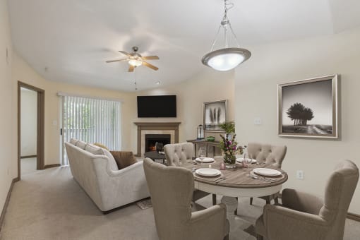 a living room with a table and chairs and a fireplace