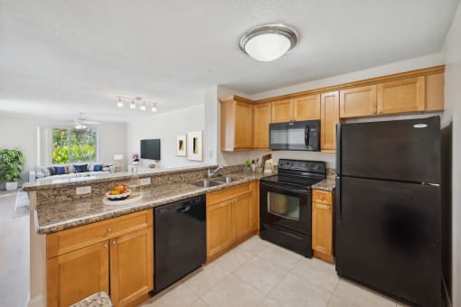 a kitchen with black appliances and granite counter tops at Gateway Club, Boynton Beach, 33436