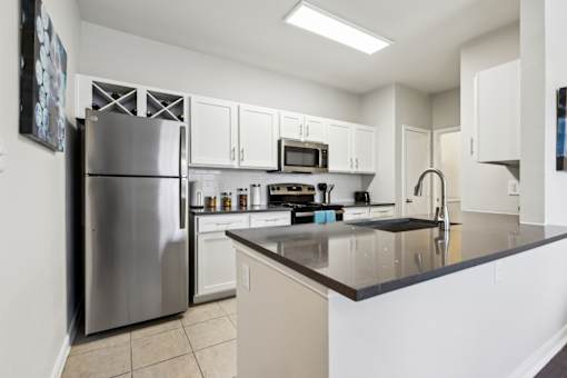 A Kitchen with a Refrigerator at Flats on Chapel Apartments, Waco, 76712