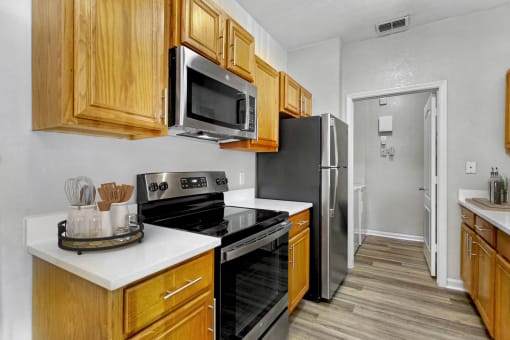 a kitchen with stainless steel appliances and wooden cabinets