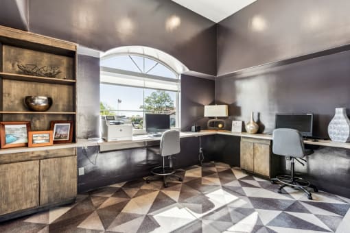 an office with two desks and two chairs and a window at Altezza High Desert, Albuquerque