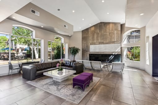 the clubhouse has a large stone fireplace and leather furniture