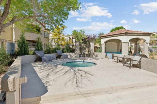 a pool and patio with chairs and a fountain at Altezza High Desert, New Mexico