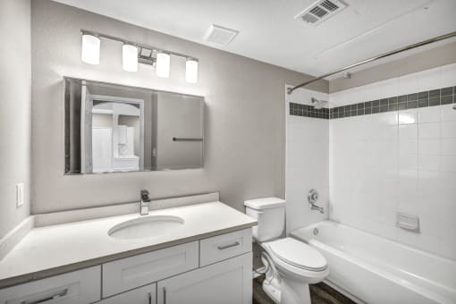 a bathroom with a sink toilet and bathtub at Stonelake at the Arboretum, Austin, TX