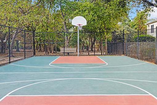 A basketball court with a net and a basketball hoop.