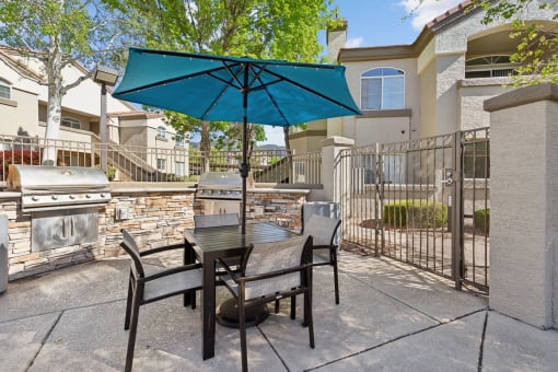 our patio has a table and chairs with an umbrella at Altezza High Desert, Albuquerque, New Mexico