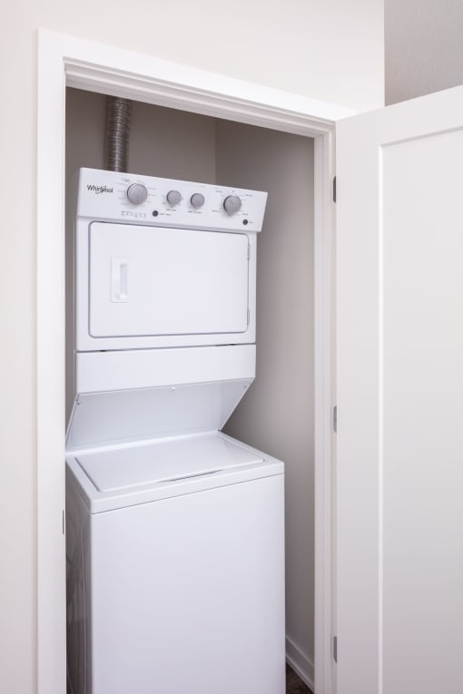 a white washer and dryer in a closet